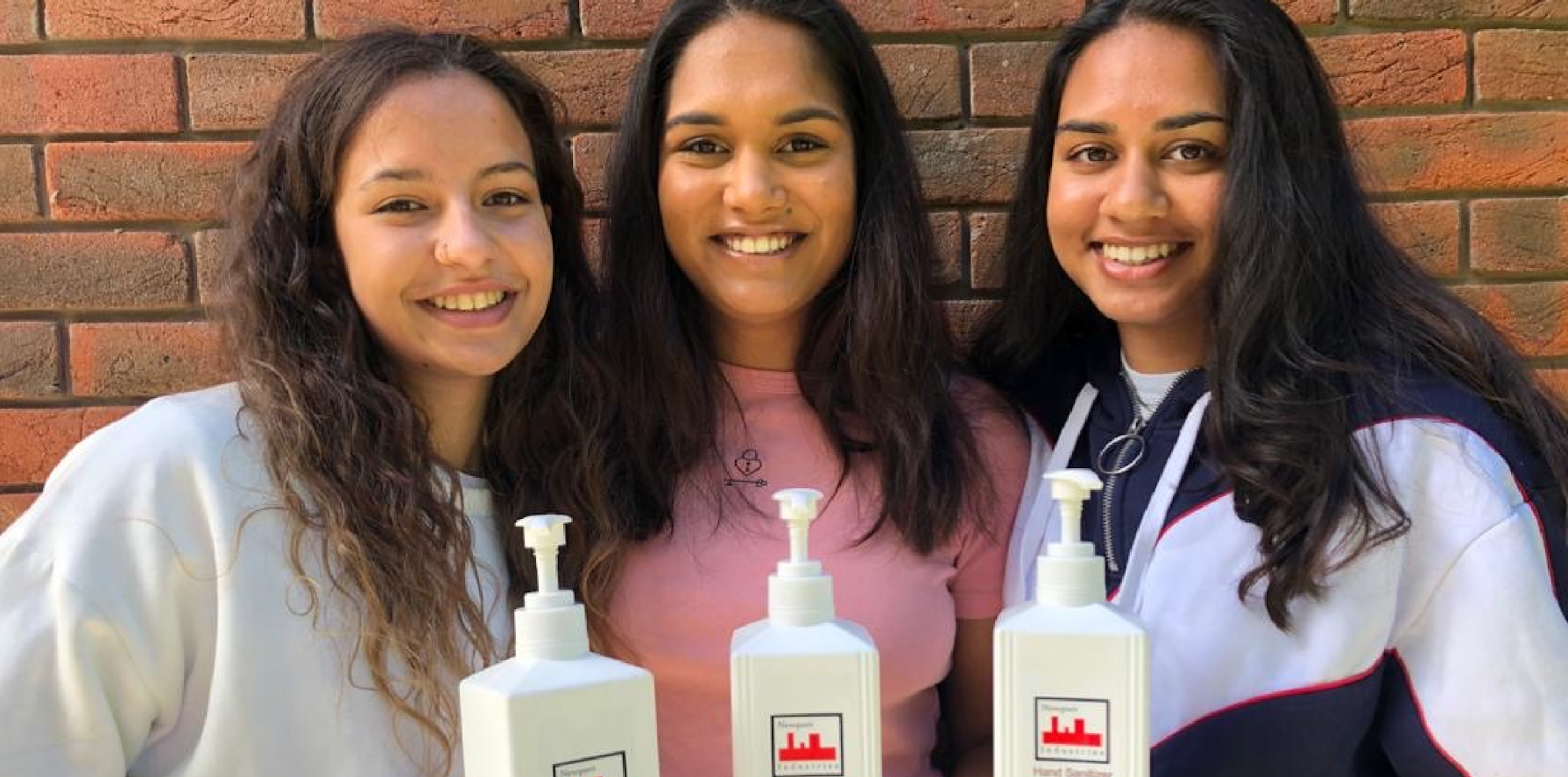 Three teenagers holding Newport Industries Hand Sanitiser